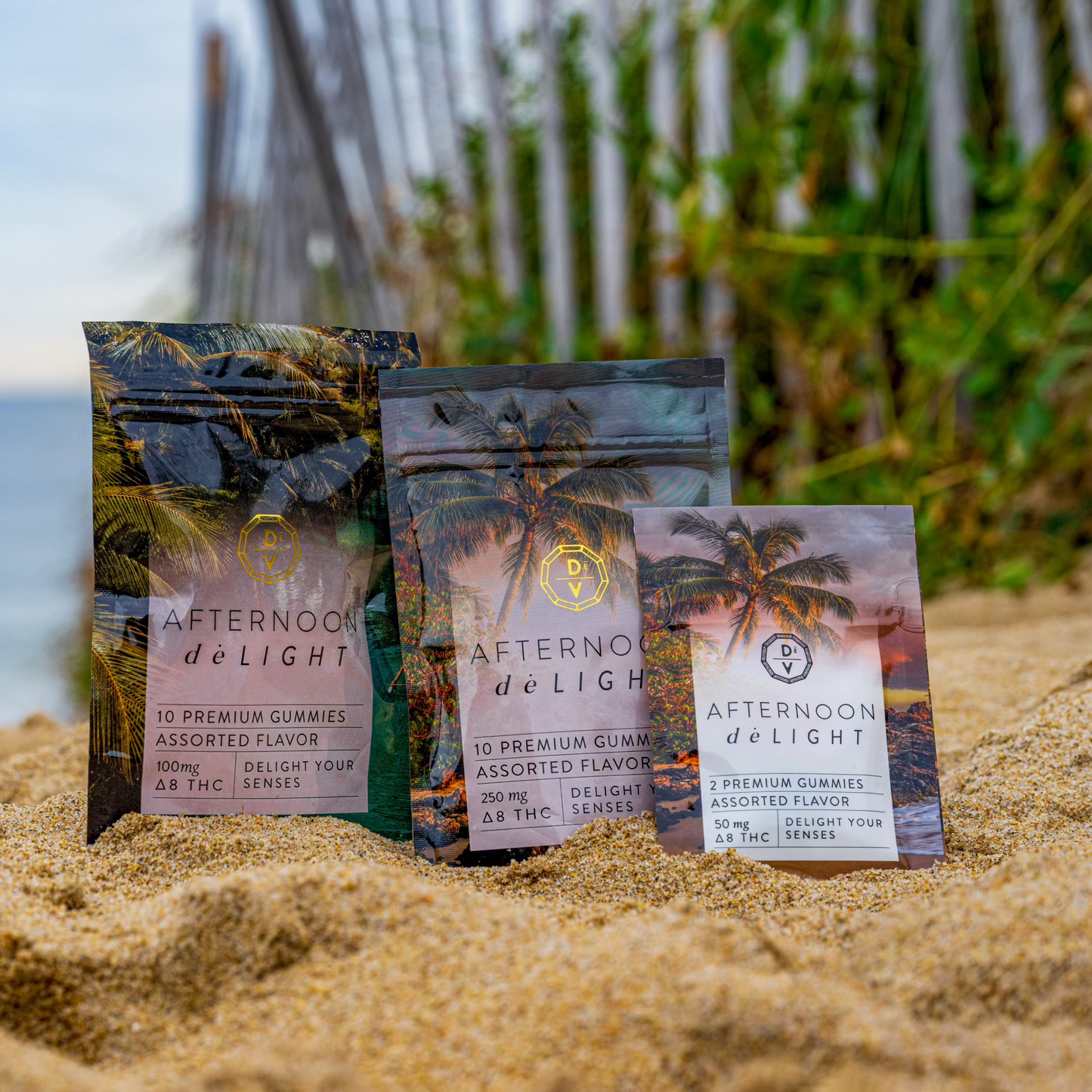 Afternoon deLIGHT ∆8 Gummies in assorted flavors and strengths displayed on sand with tropical background.